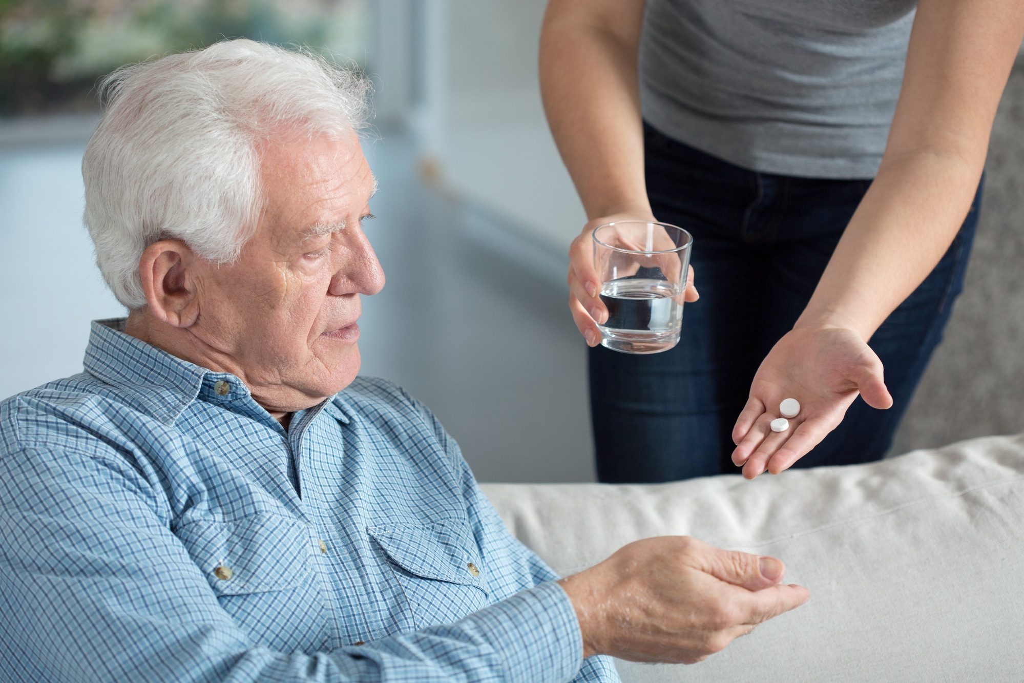 Ill senior man taking medicine